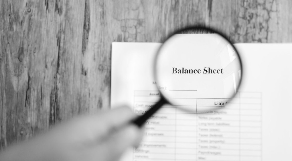 A balance sheet under a magnifying glass